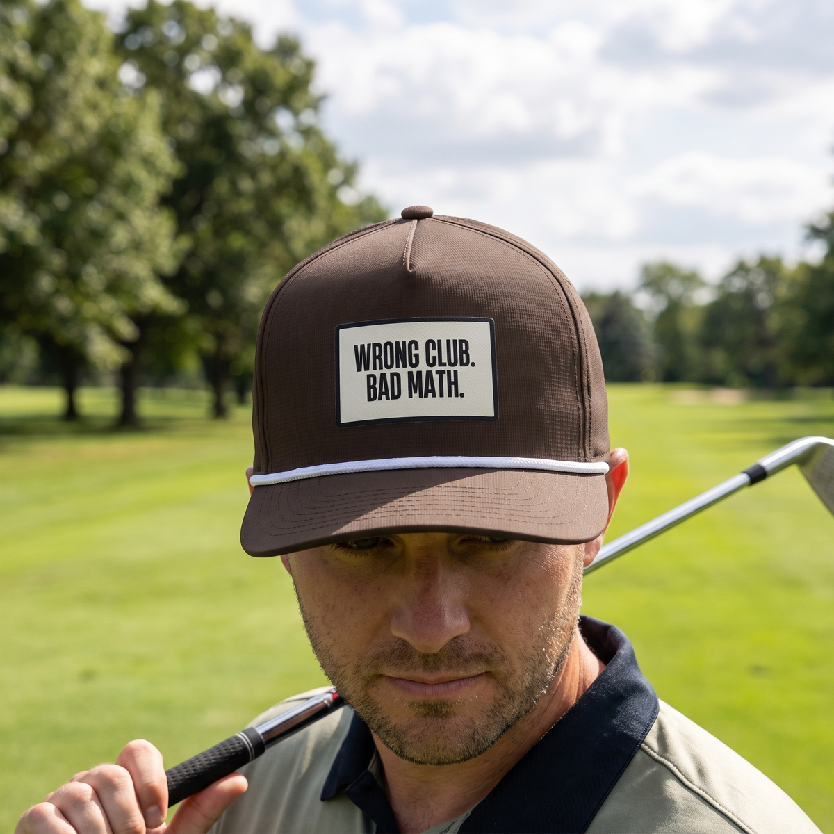 A golfer on a golf course wearing the Wrong Club. Bad Math. rope hat in Espresso with a white rope.