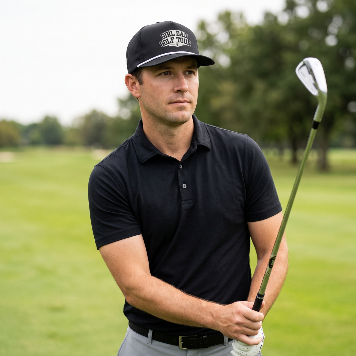 A golfer on a golf course wearing the Girl Dad Golf Tour rope hat in Black with a white rope.