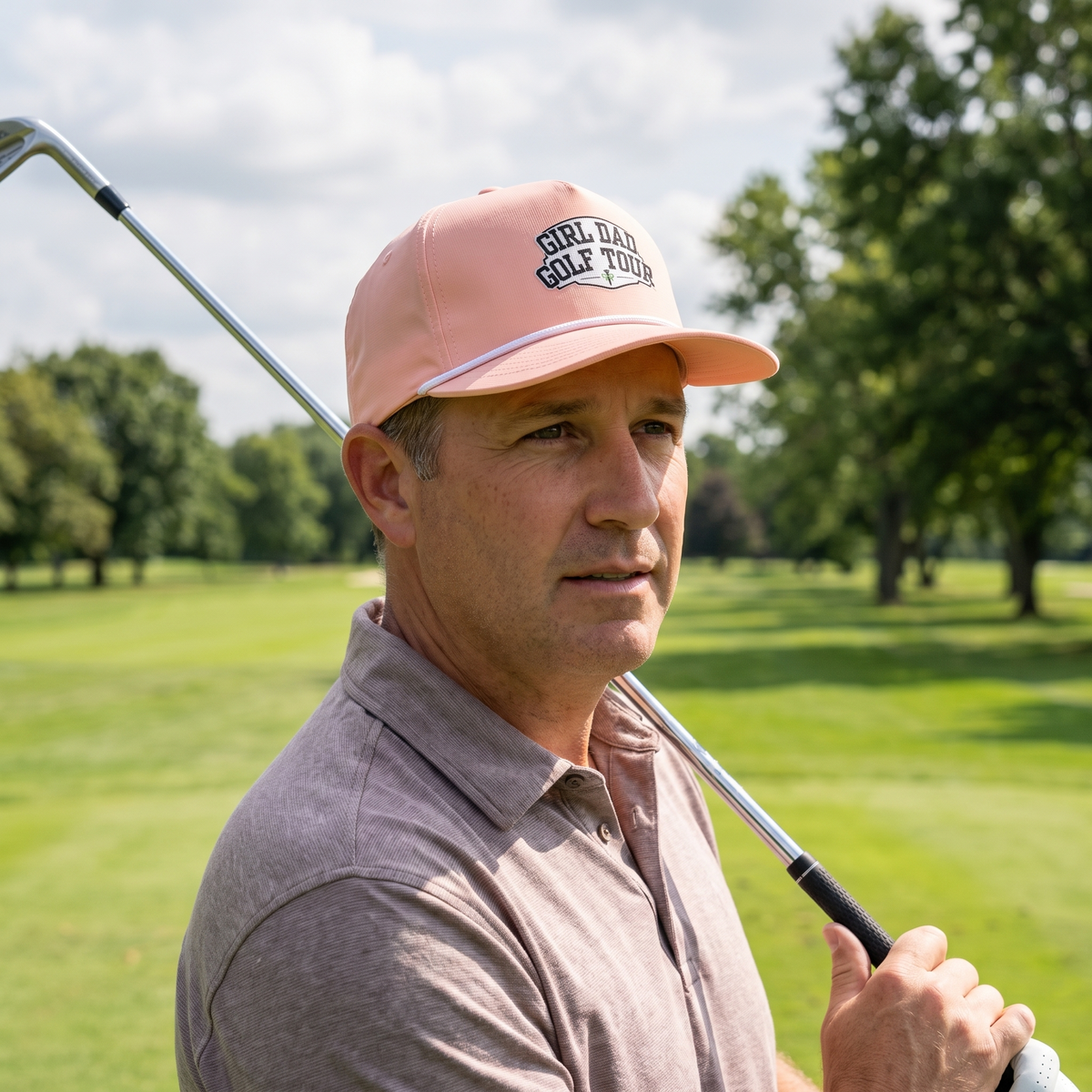 A golfer on a golf course wearing the Girl Dad Golf Tour rope hat in Peachy with a white rope.