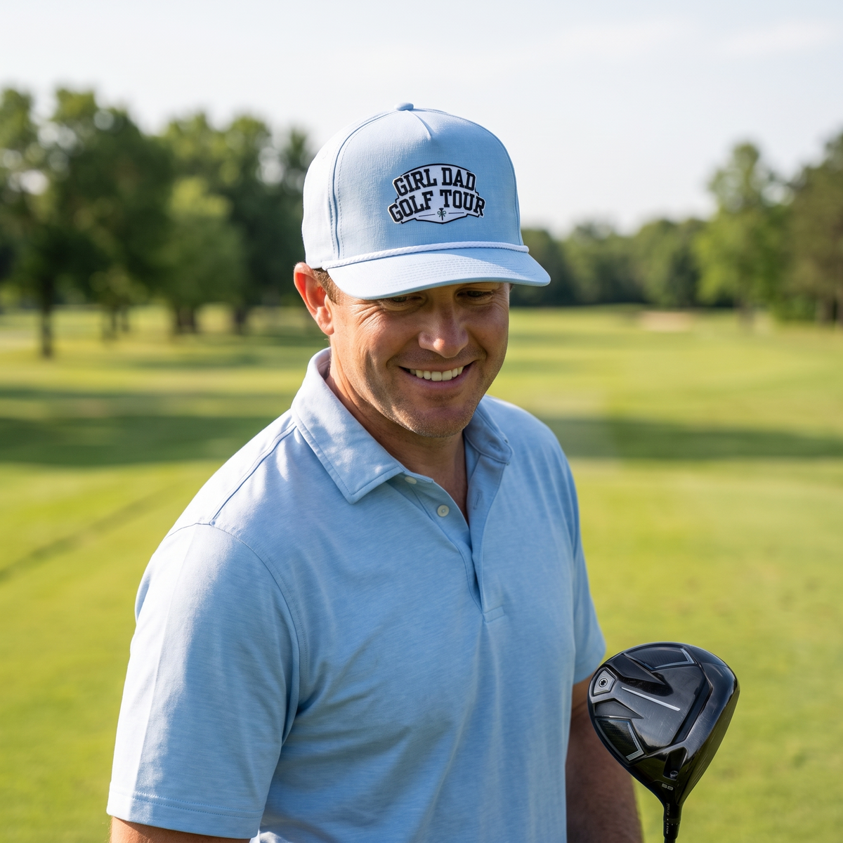 A golfer on a golf course wearing the Girl Dad Golf Tour rope hat in Chambray with a white rope.