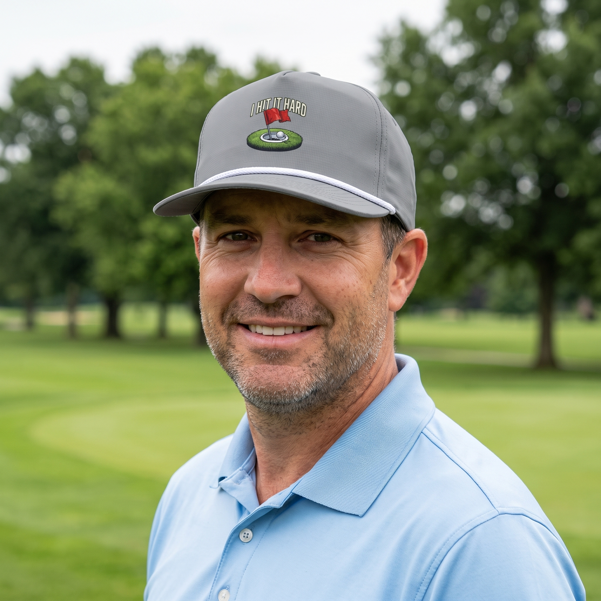 A golfer on a golf course wearing the I Hit It Hard rope hat in Granite with a white rope.