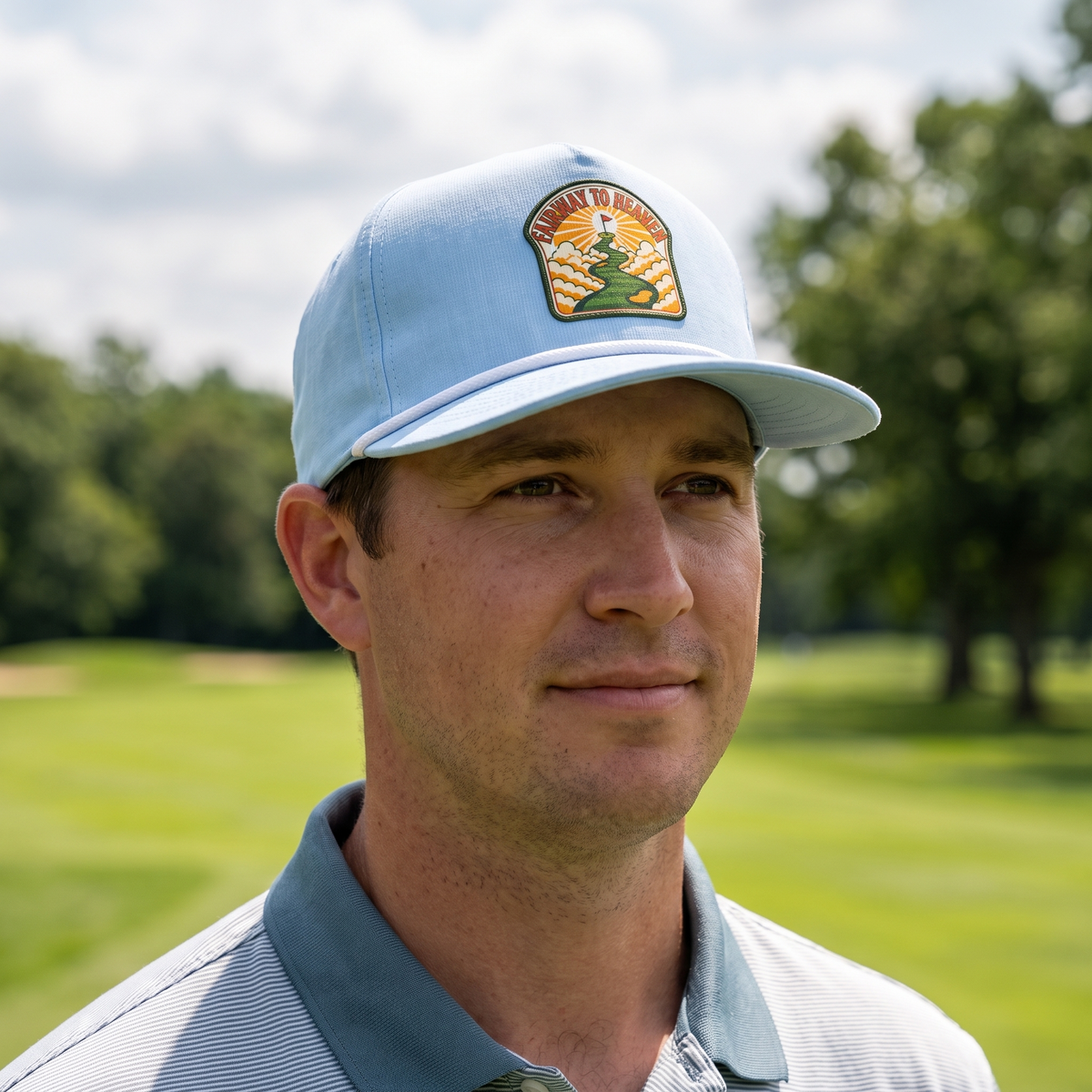A golfer on a golf course wearing the Fairway to Heaven rope hat in Chambray with a white rope.